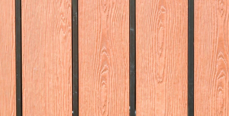 Close-up view of vertical wooden panels with visible grain pattern, separated by thin black lines.
