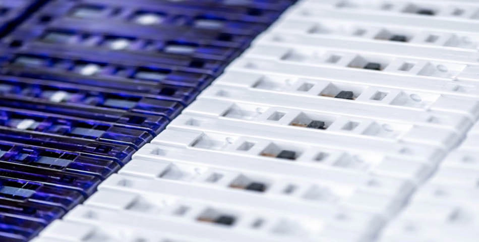 Rows of blue and white plastic rapid test cassettes are arranged closely together, viewed from above.