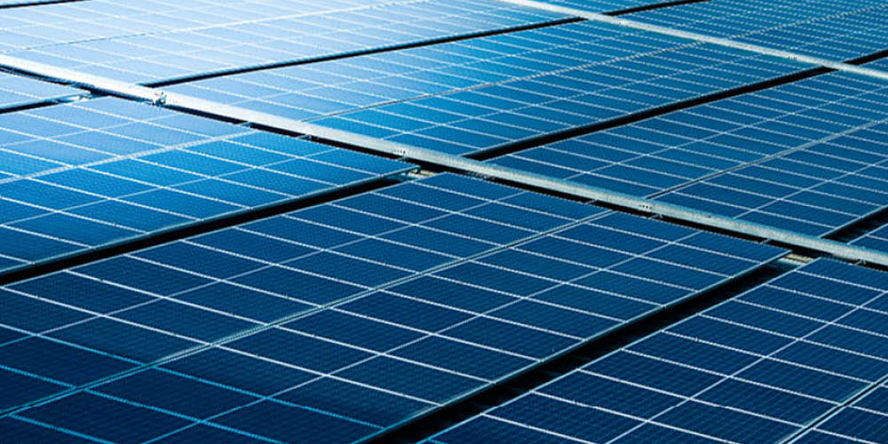 Close-up view of multiple blue solar panels arranged in rows, capturing sunlight for renewable energy generation.