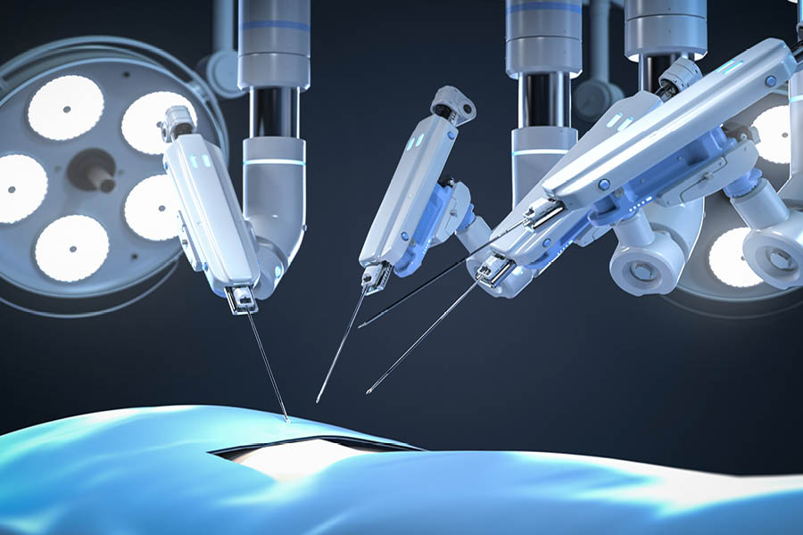 Robotic surgical arms operate over a patient under bright surgical lights in an operating room, performing a minimally invasive procedure.